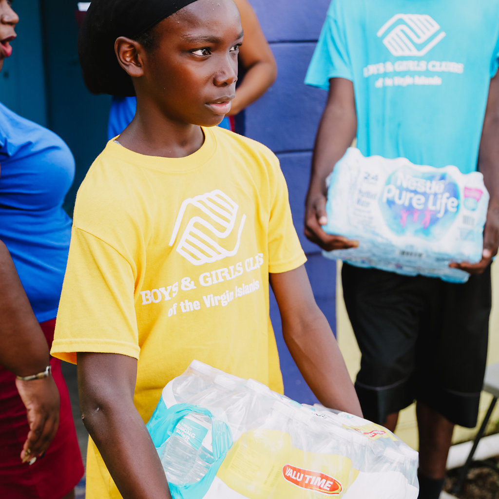 Cane Bay Cares distributes water at the Boys and Girls Club in Frederiksted in the aftermath of Hurricane Maria. Photo Credit: http://nicolecanegata.com/