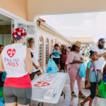 Cane Bay Partners volunteers distribute several thousand pounds of food, hundreds of LUCI solar lights and 6 pallets of water donated by St. Croix Foundation at Zion Christian Academy on Saturday, Nov. 11. Photo credit: Nicole Canegata http://nicolecanegata.com/