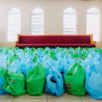 Cane Bay Partners volunteers distribute several thousand pounds of food, hundreds of LUCI solar lights and 6 pallets of water donated by St. Croix Foundation at Zion Christian Academy on Saturday, Nov. 11. Photo credit: Nicole Canegata http://nicolecanegata.com/