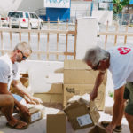 Cane Bay Partners volunteers distribute several thousand pounds of food, hundreds of LUCI solar lights and 6 pallets of water donated by St. Croix Foundation at Zion Christian Academy on Saturday, Nov. 11. Photo credit: Nicole Canegata http://nicolecanegata.com/