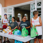 Cane Bay Partners volunteers distribute several thousand pounds of food, hundreds of LUCI solar lights and 6 pallets of water donated by St. Croix Foundation at Zion Christian Academy on Saturday, Nov. 11. Photo credit: Nicole Canegata http://nicolecanegata.com/