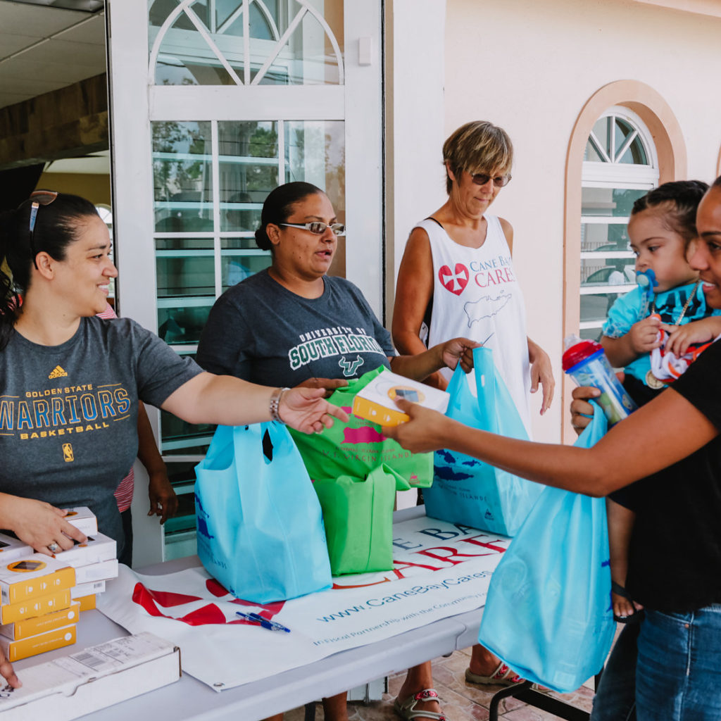 Cane Bay Partners volunteers distribute several thousand pounds of food, hundreds of LUCI solar lights and 6 pallets of water donated by St. Croix Foundation at Zion Christian Academy on Saturday, Nov. 11. Photo credit: Nicole Canegata http://nicolecanegata.com/