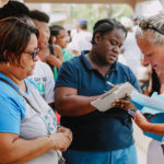 Cane Bay Partners volunteers distribute several thousand pounds of food, hundreds of LUCI solar lights and 6 pallets of water donated by St. Croix Foundation at Zion Christian Academy on Saturday, Nov. 11. Photo credit: Nicole Canegata http://nicolecanegata.com/