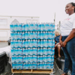 Cane Bay Partners volunteers distribute several thousand pounds of food, hundreds of LUCI solar lights and 6 pallets of water donated by St. Croix Foundation at Zion Christian Academy on Saturday, Nov. 11. Photo credit: Nicole Canegata http://nicolecanegata.com/