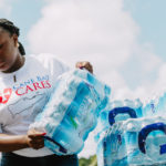Cane Bay Partners volunteers distribute several thousand pounds of food, hundreds of LUCI solar lights and 6 pallets of water donated by St. Croix Foundation at Zion Christian Academy on Saturday, Nov. 11. Photo credit: Nicole Canegata http://nicolecanegata.com/