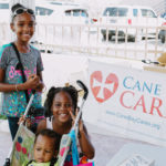 Cane Bay Partners volunteers distribute several thousand pounds of food, hundreds of LUCI solar lights and 6 pallets of water donated by St. Croix Foundation at Zion Christian Academy on Saturday, Nov. 11. Photo credit: Nicole Canegata http://nicolecanegata.com/