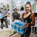 Cane Bay Partners volunteers distribute several thousand pounds of food, hundreds of LUCI solar lights and 6 pallets of water donated by St. Croix Foundation at Zion Christian Academy on Saturday, Nov. 11. Photo credit: Nicole Canegata http://nicolecanegata.com/