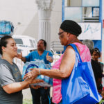Cane Bay Partners volunteers distribute several thousand pounds of food, hundreds of LUCI solar lights and 6 pallets of water donated by St. Croix Foundation at Zion Christian Academy on Saturday, Nov. 11. Photo credit: Nicole Canegata http://nicolecanegata.com/