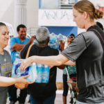 Cane Bay Partners volunteers distribute several thousand pounds of food, hundreds of LUCI solar lights and 6 pallets of water donated by St. Croix Foundation at Zion Christian Academy on Saturday, Nov. 11. Photo credit: Nicole Canegata http://nicolecanegata.com/
