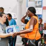 Cane Bay Partners volunteers distribute several thousand pounds of food, hundreds of LUCI solar lights and 6 pallets of water donated by St. Croix Foundation at Zion Christian Academy on Saturday, Nov. 11. Photo credit: Nicole Canegata http://nicolecanegata.com/