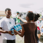 Cane Bay Partners volunteers distribute several thousand pounds of food, hundreds of LUCI solar lights and 6 pallets of water donated by St. Croix Foundation at Zion Christian Academy on Saturday, Nov. 11. Photo credit: Nicole Canegata http://nicolecanegata.com/