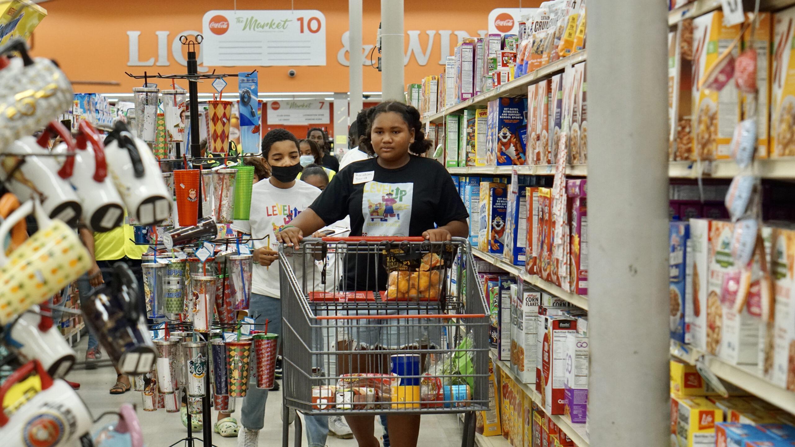 Preteens race through the Market STX for a chance to win cash prizes in a reinvented "Supermarket Sweep" hosted by Cane Bay Cares.