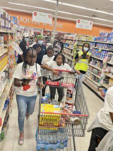 Level Up with Fruits and Veggies Nutrition Fair participants race through the Market STX during a reinvented 'Supermarket Sweep' scavenger hunt for preteens hosted by Cane Bay Cares.