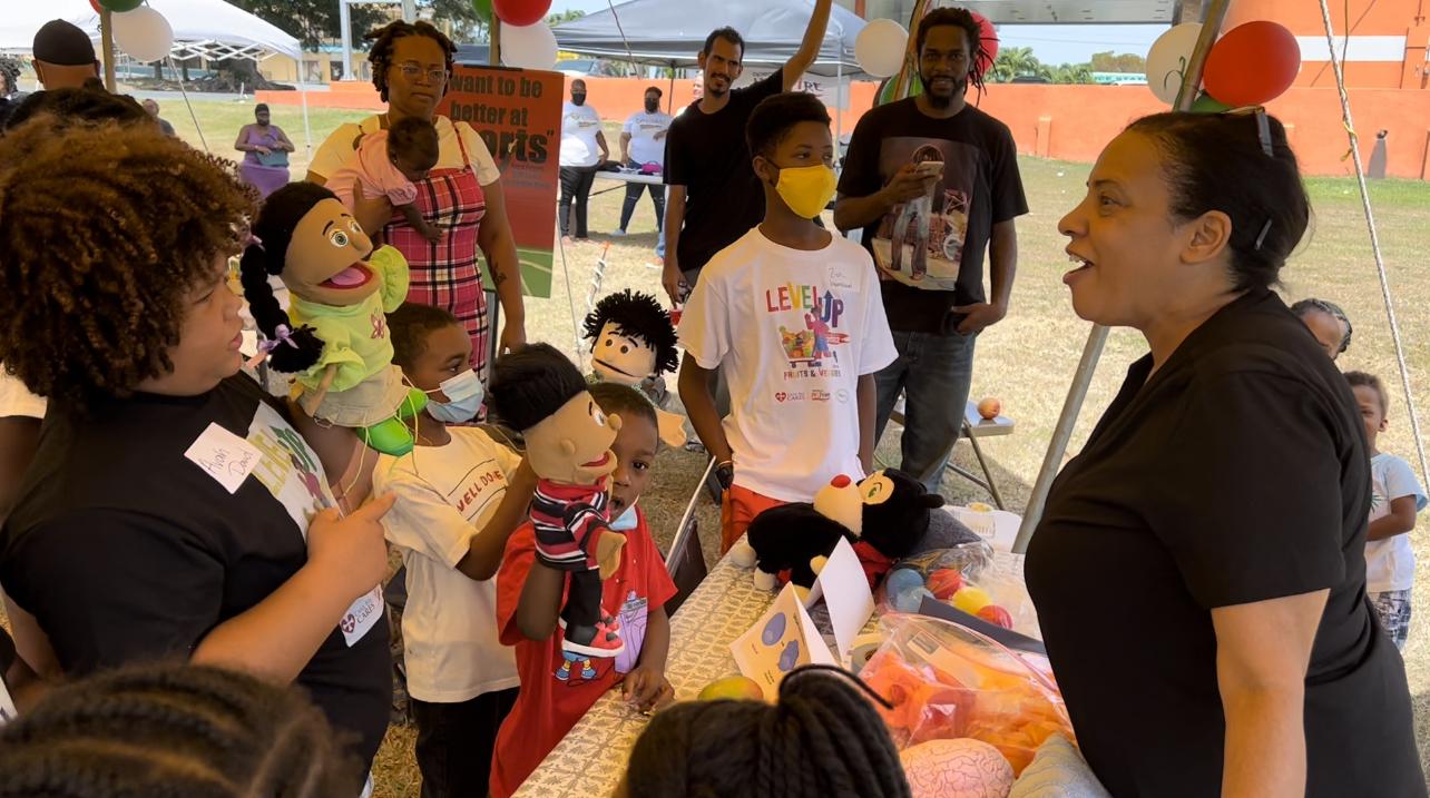 Linda Gallo Ambrose, NCC Health and Children's Ministries Director, helps preteens explore how nutrition can help them increase concentration during the 2022 "Level Up with Fruits and Veggies" Nutrition Fair hosted by Cane Bay Cares.