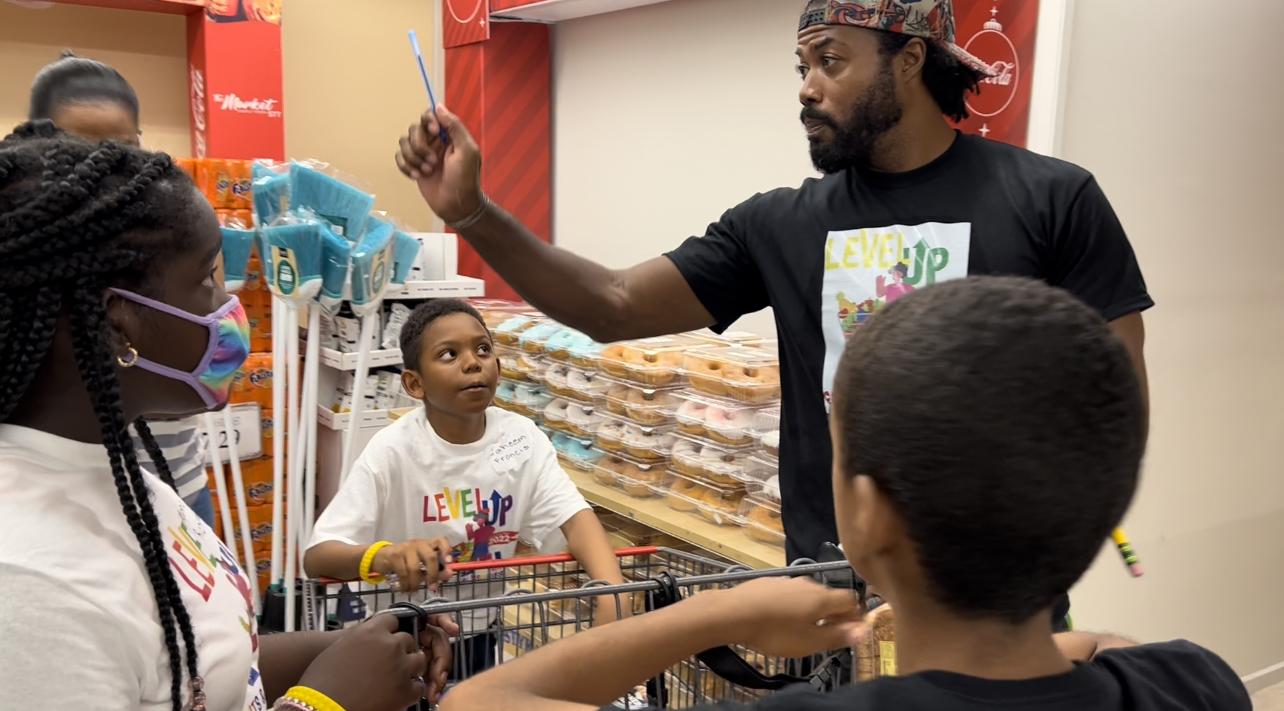 Justin C. Smith of the Lion Haven St. Croix Community Center tallies team scores during a reinvented 'Supermarket Sweep' at the 2022 Level Up with Fruits and Veggies Nutrition Fair hosted by Cane Bay Cares.