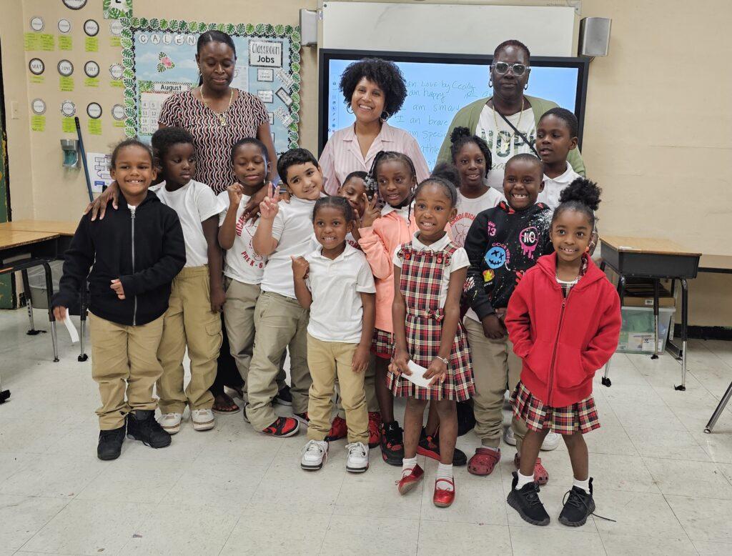 Following her presentation on music, Cecily Bumbray, artist-in-residence at CMC Arts, Inc., takes a moment to take a photo with students.