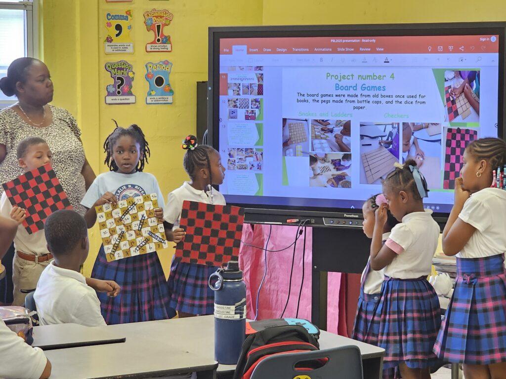 “Recycle, Reuse, Reduce” students proudly explain how they made board games from recycled materials. “Recycle, Reuse, Reduce” students proudly explain how they made board games from recycled materials.